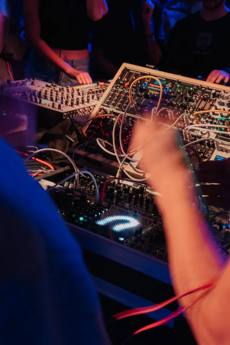 Een deelnemer speelt op een modulaire synthesizer tijdens een muziekworkshop